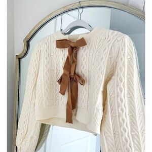 Storia Cream Cable-Knit Crewneck Sweater with Brown Ribbon Back Detail